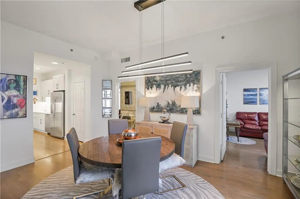 Dining area featuring light hardwood / wood-style floors and a stone fireplace