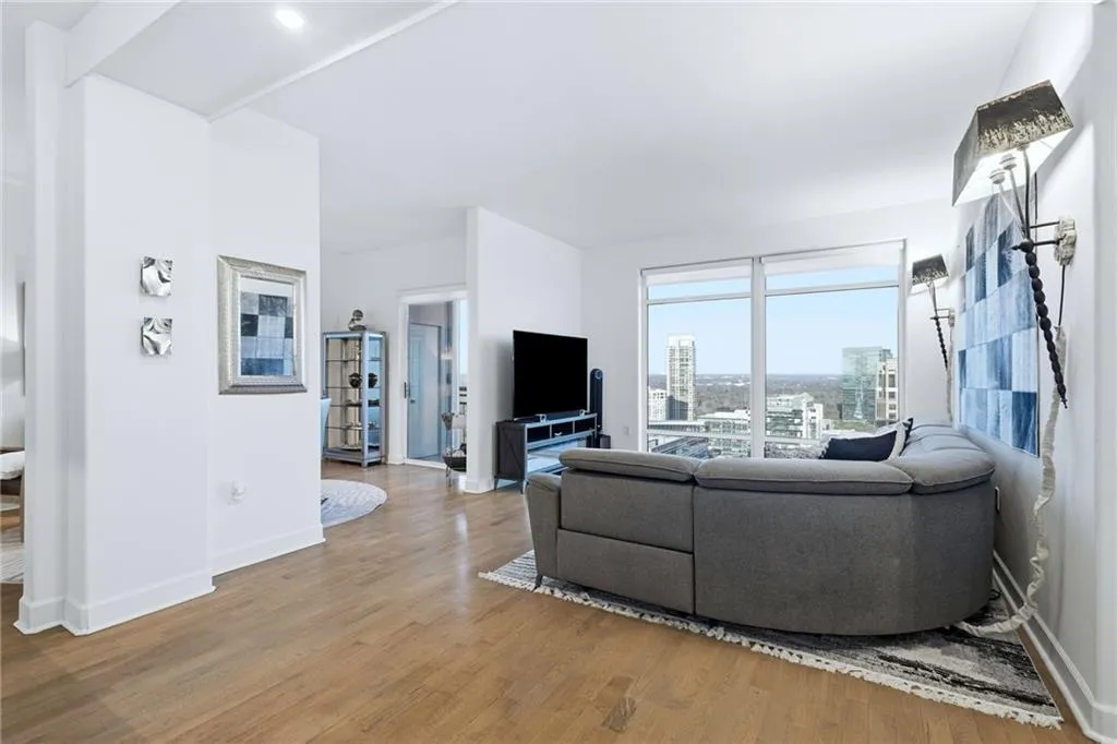 Living area with light wood-style flooring and baseboards