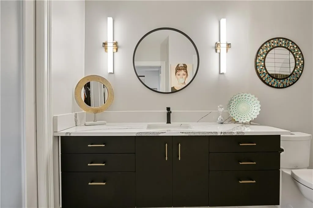 Bathroom with dual bowl vanity and toilet