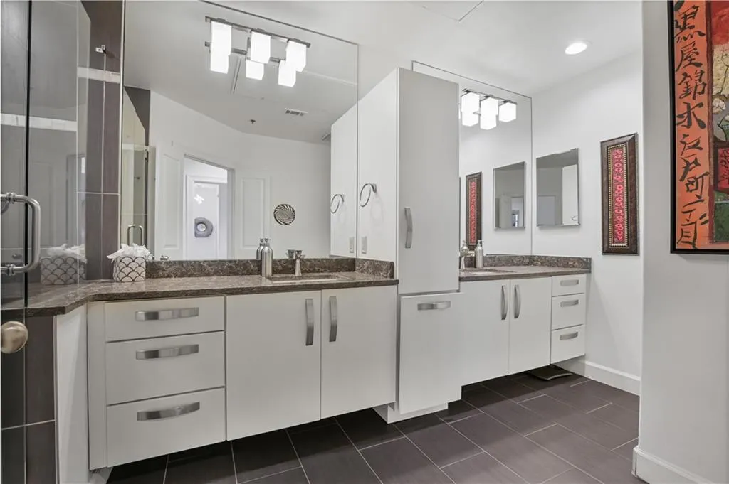 Bathroom featuring dual vanity and tile floors