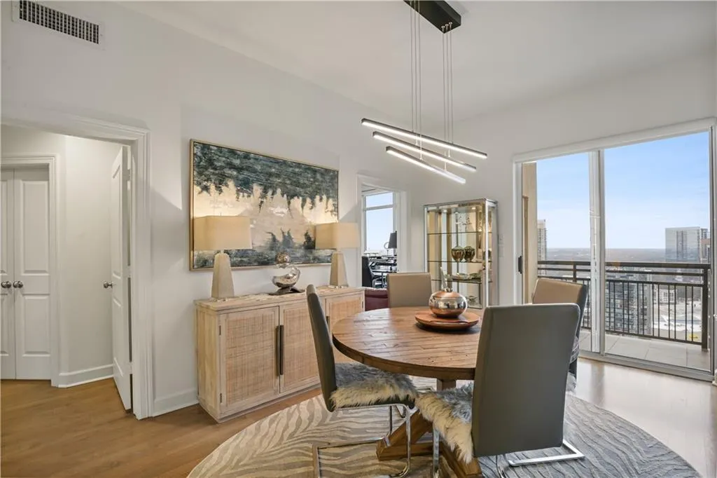 Dining room featuring a chandelier, light hardwood / wood-style flooring, and a healthy amount of sunlight