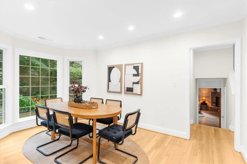 Dining room with light wood-style floors, recessed lighting, and crown molding