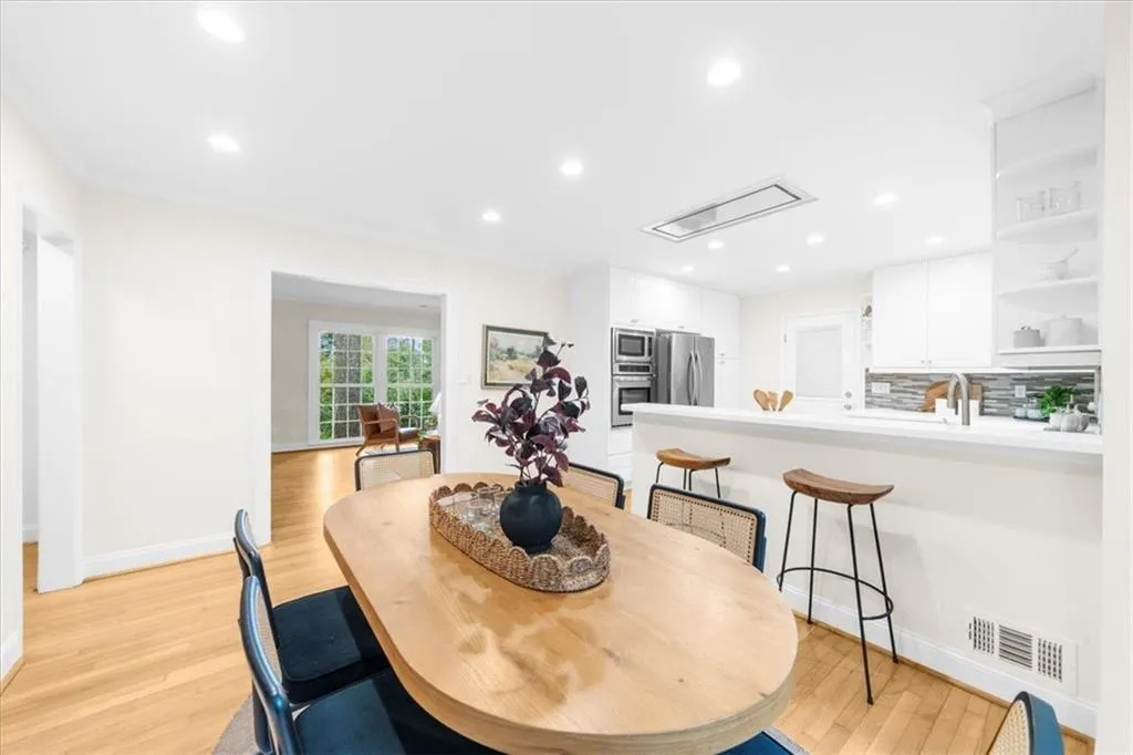 Dining area featuring light wood-style flooring, recessed lighting, and attic access