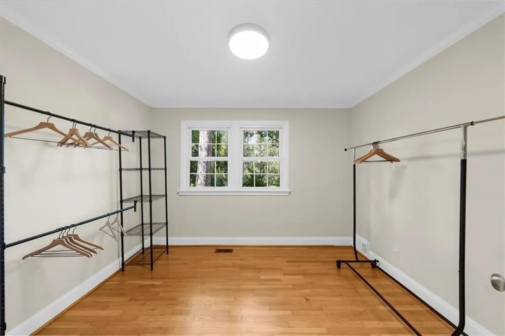 Unfurnished bedroom featuring light wood-type flooring and ornamental molding
