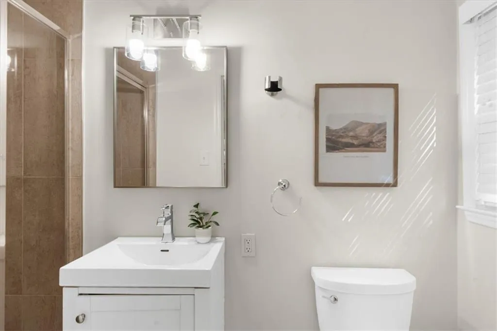 Full bathroom with vanity and a stall shower