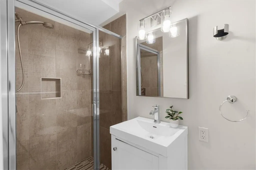 Bathroom with vanity and a stall shower