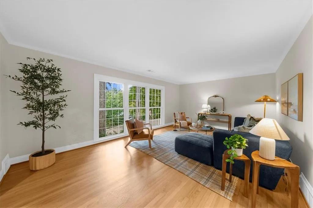 Living room featuring light wood-type flooring and crown molding