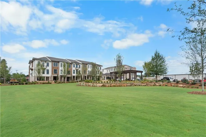 Front elevation of the building not the actual unit , common green area for every owner to enjoy with a firepit . Not the actual building or unit .