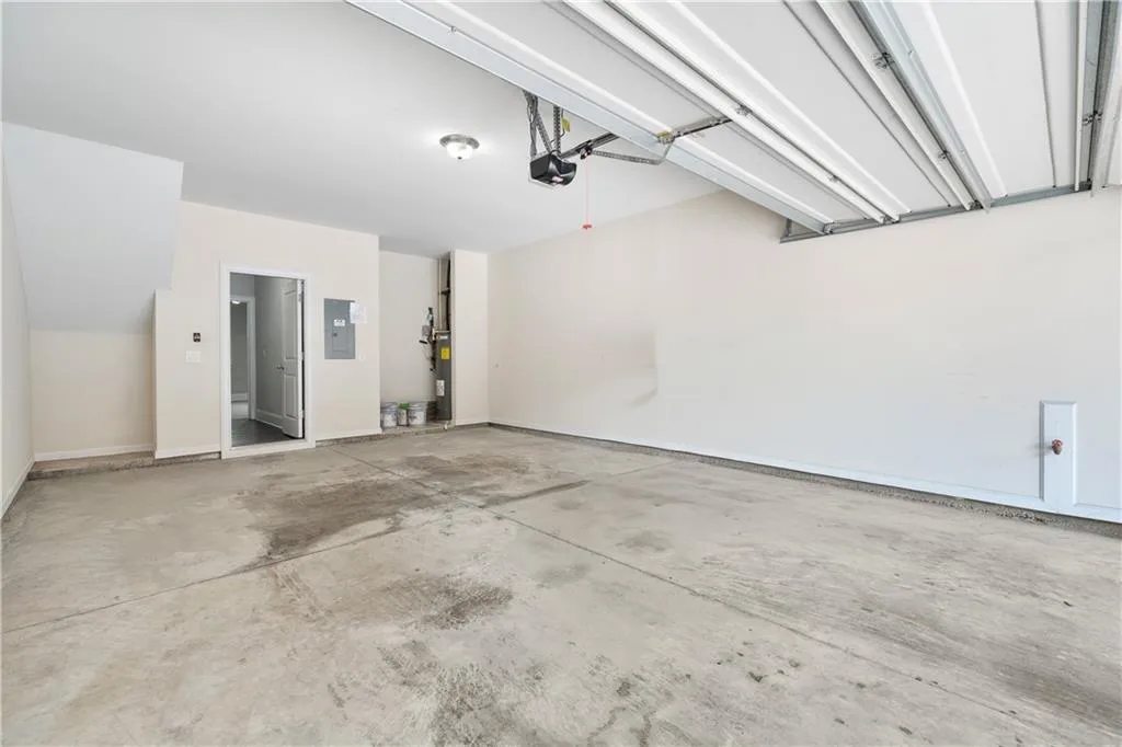 Garage with electric panel and a garage door opener