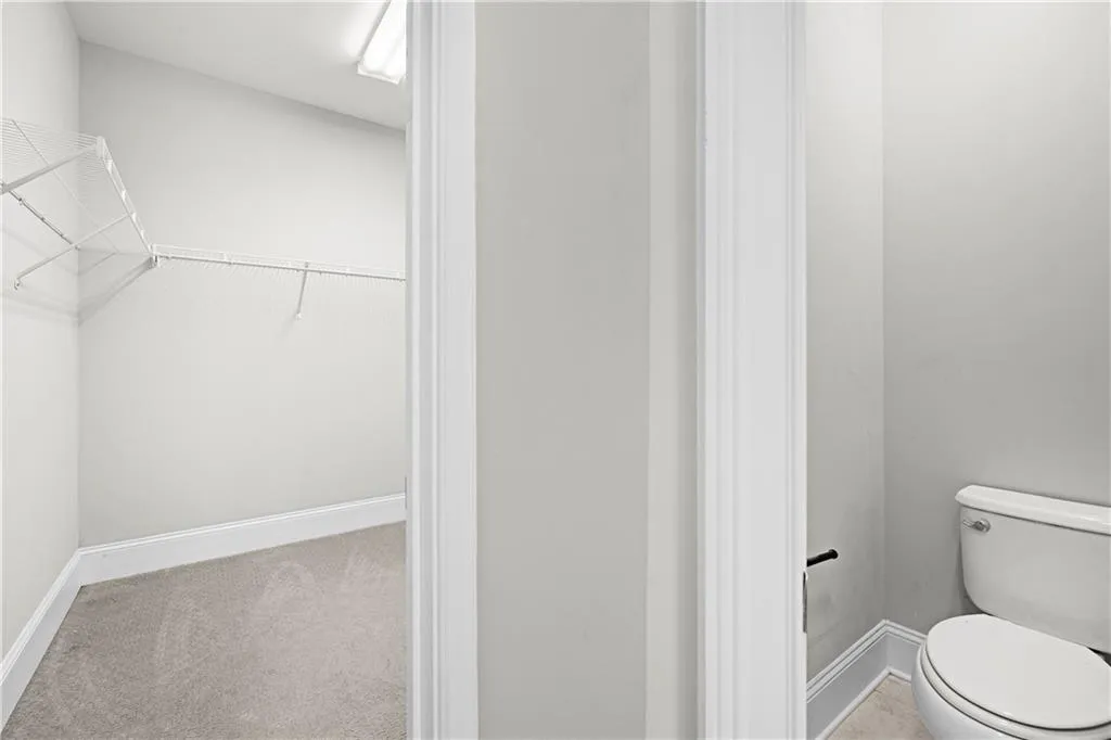 Bathroom with baseboards and a walk in closet