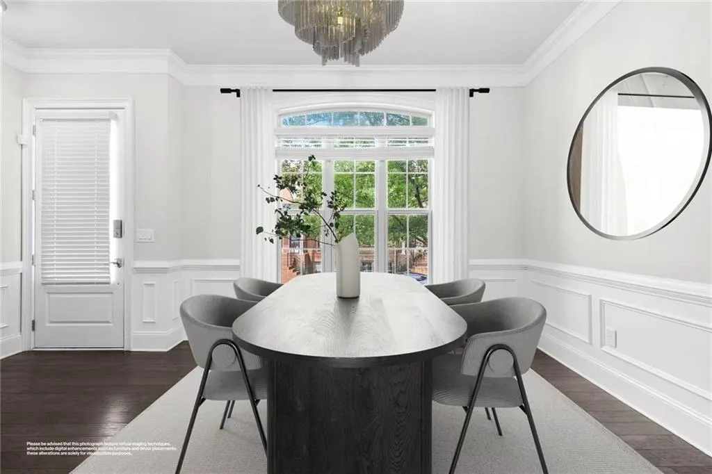 Dining area with wainscoting, crown molding, a decorative wall, a chandelier, and dark wood finished floors
