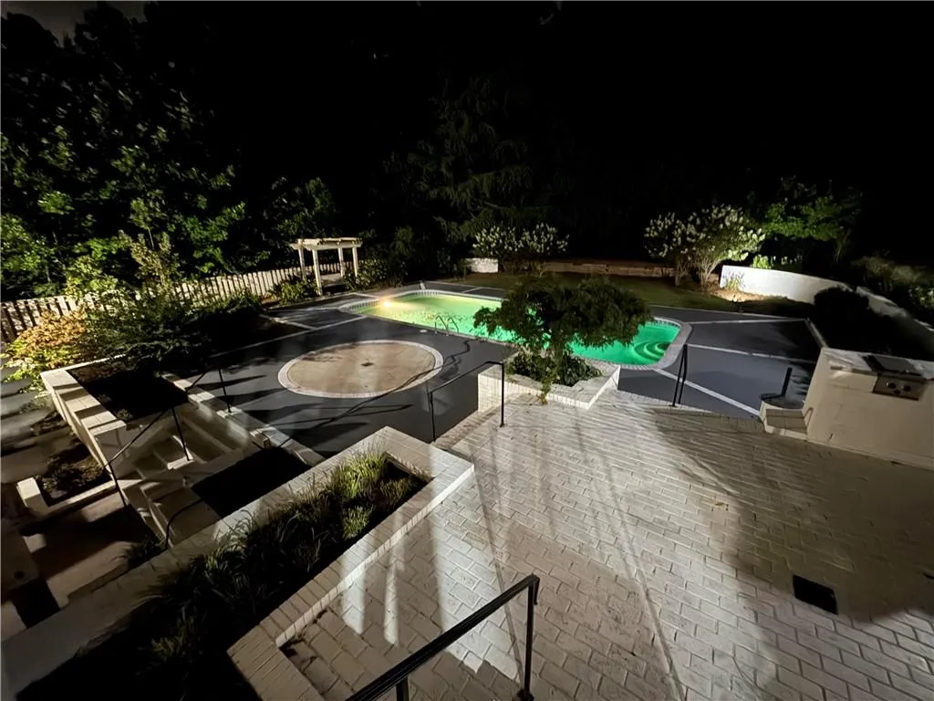 Pool at night with a patio