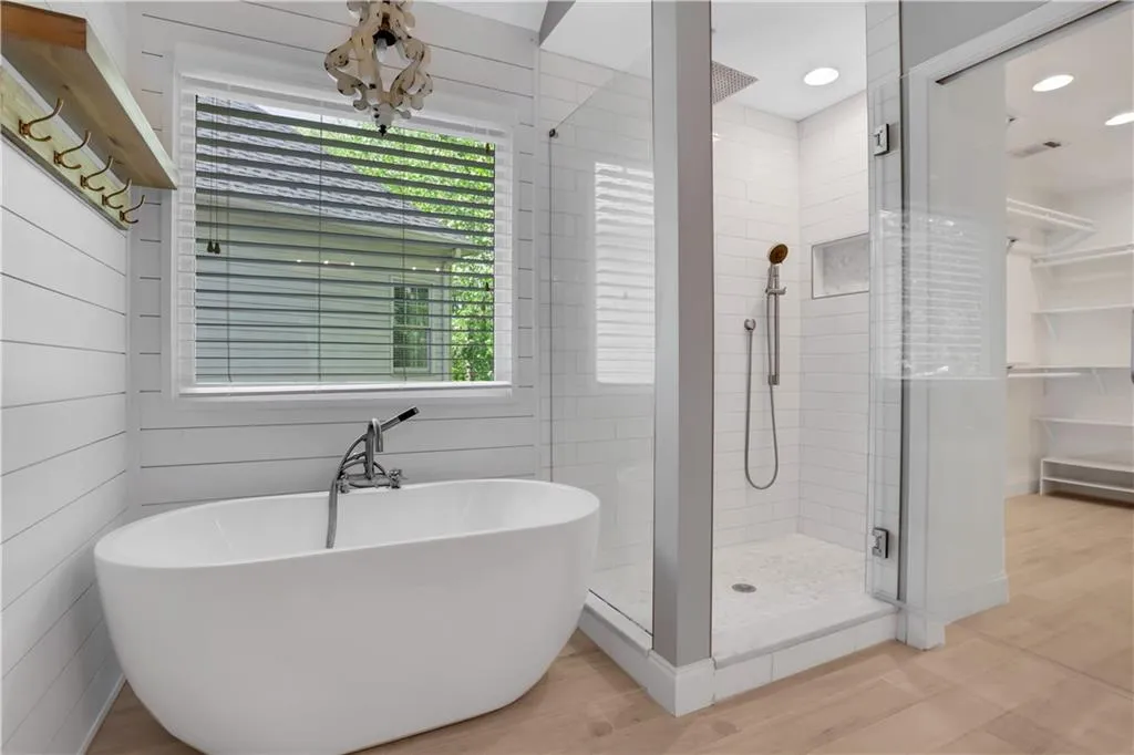 Bathroom with plus walk in shower and hardwood / wood-style flooring Bathroom with plus walk in shower and hardwood / wood-style flooring