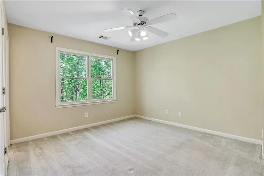 Carpeted spare room featuring ceiling fan Carpeted spare room featuring ceiling fan