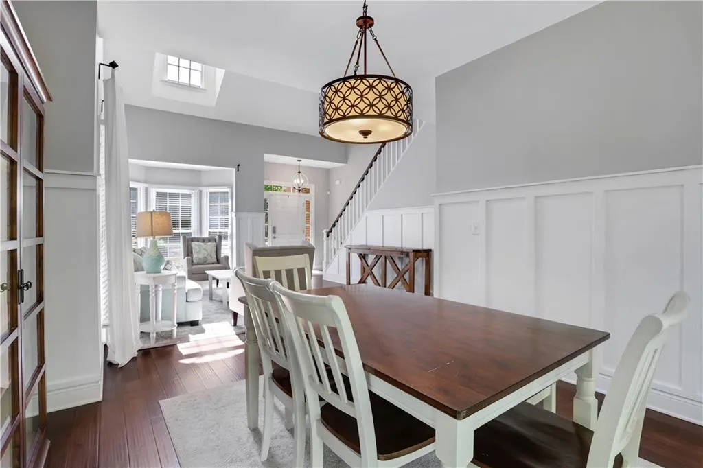 Dining space featuring a skylight, dark hardwood / wood-style flooring, and a chandelier Dining space featuring a skylight, dark hardwood / wood-style flooring, and a chandelier