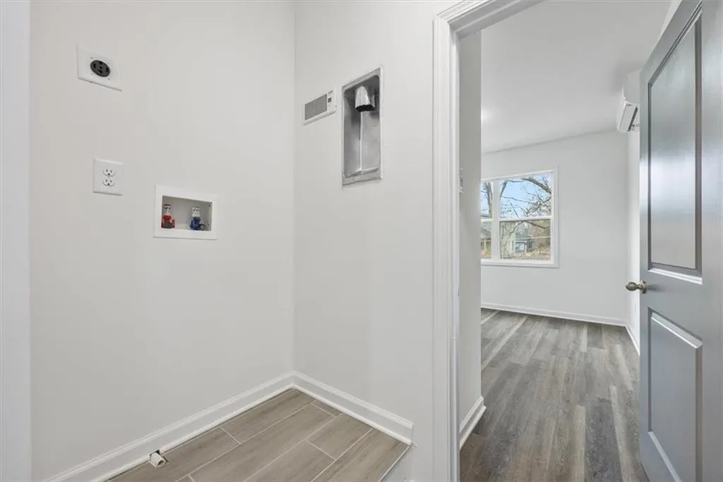 Laundry room featuring washer hookup, wood-type flooring, and hookup for an electric dryer