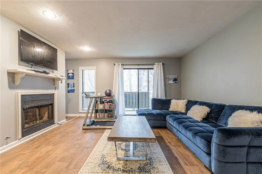 Living room featuring a textured ceiling and hardwood / wood-style floors