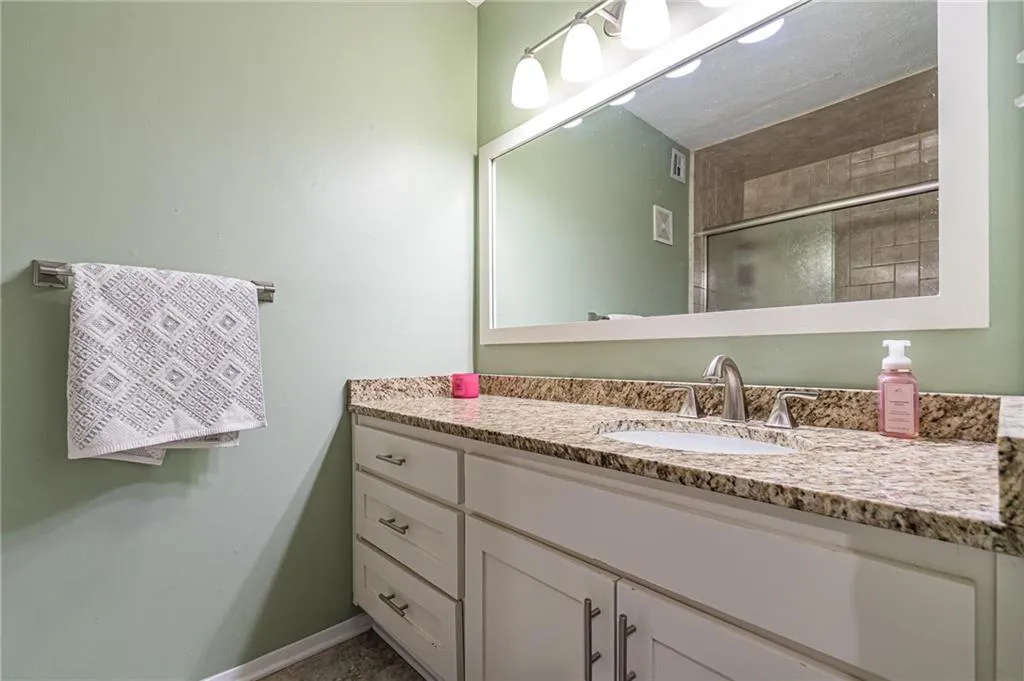 Bathroom with vanity with extensive cabinet space