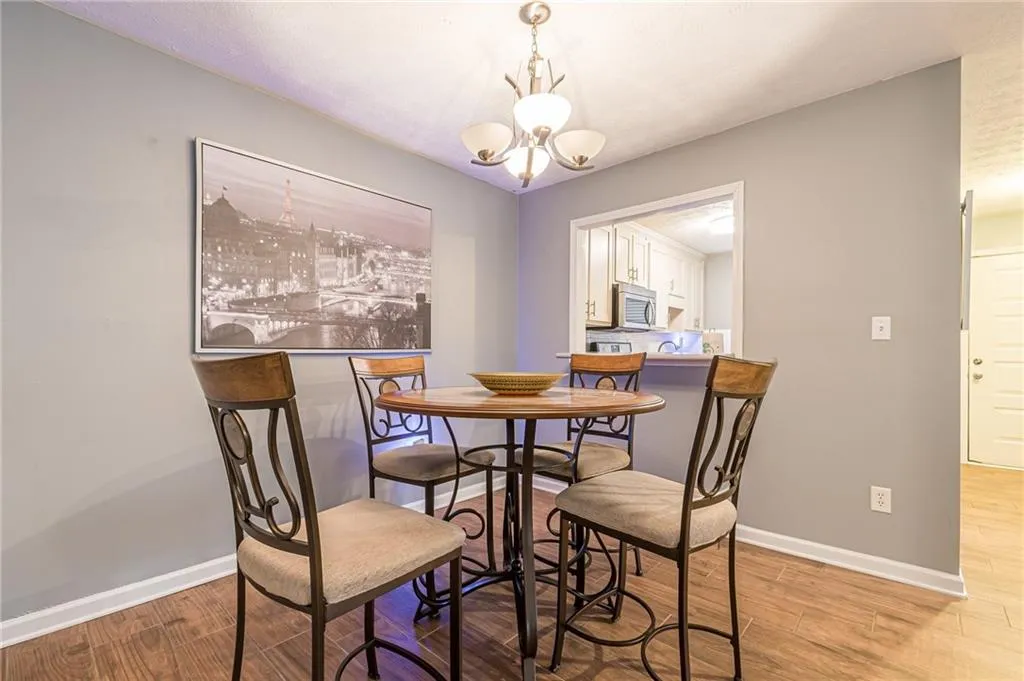 Dining space featuring an inviting chandelier and hardwood / wood-style floors