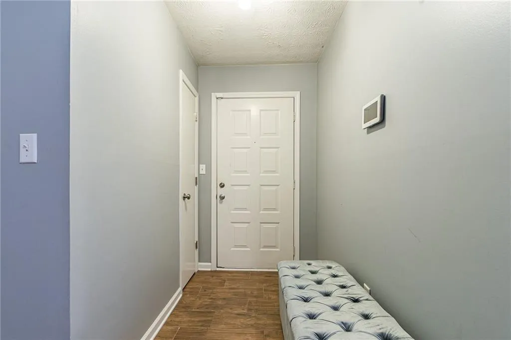 Entryway featuring a textured ceiling and dark wood-type flooring