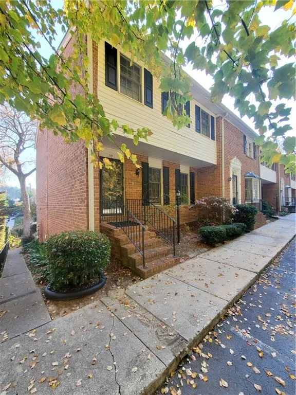 View of front of property featuring brick siding and covered porch