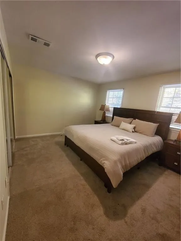 Carpeted bedroom with baseboards