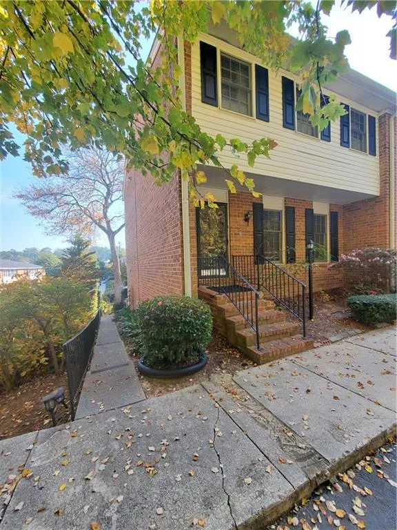 Colonial house with brick siding and covered porch