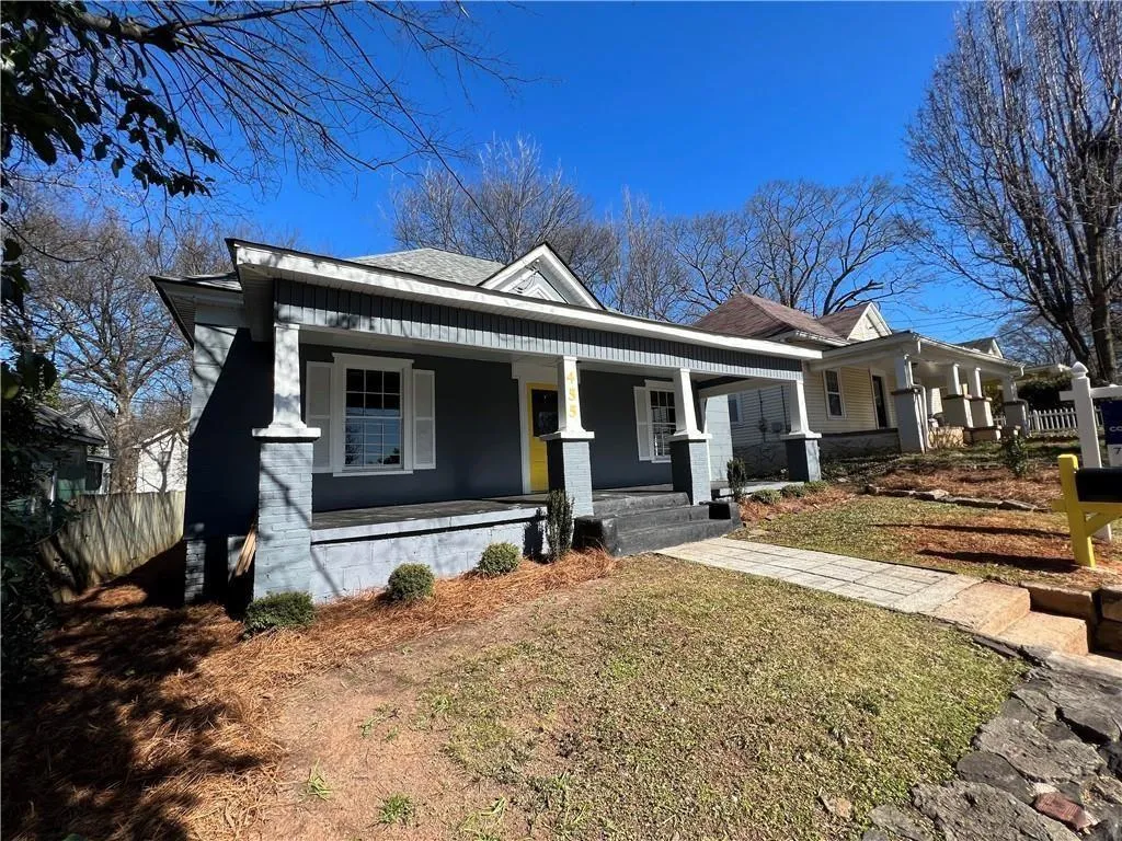 Bungalow-style home featuring fence and covered porch