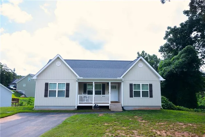 Ranch-style exterior with gabled roof lines and vertical siding accents