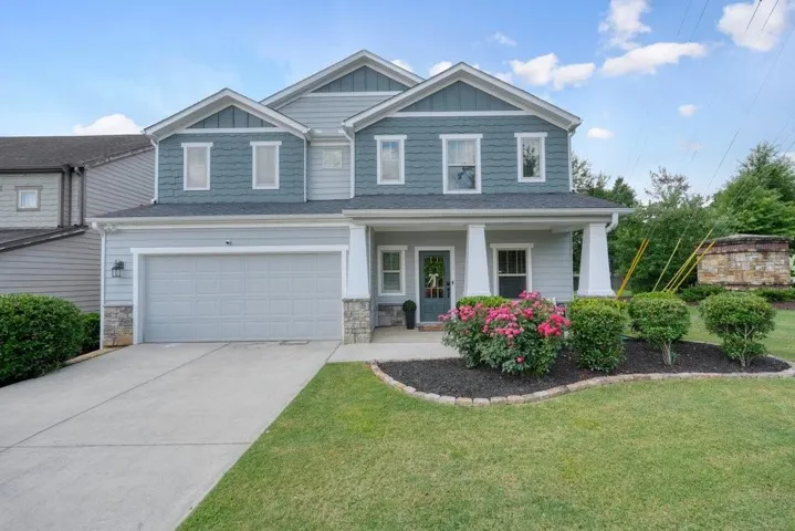 Two-story exterior with light blue siding and dark blue shake accents