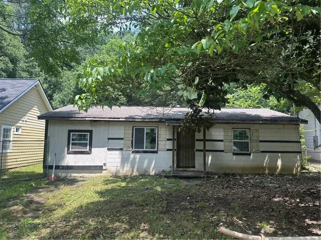 Single-story structure with a composition shingle roof and a concrete block foundation