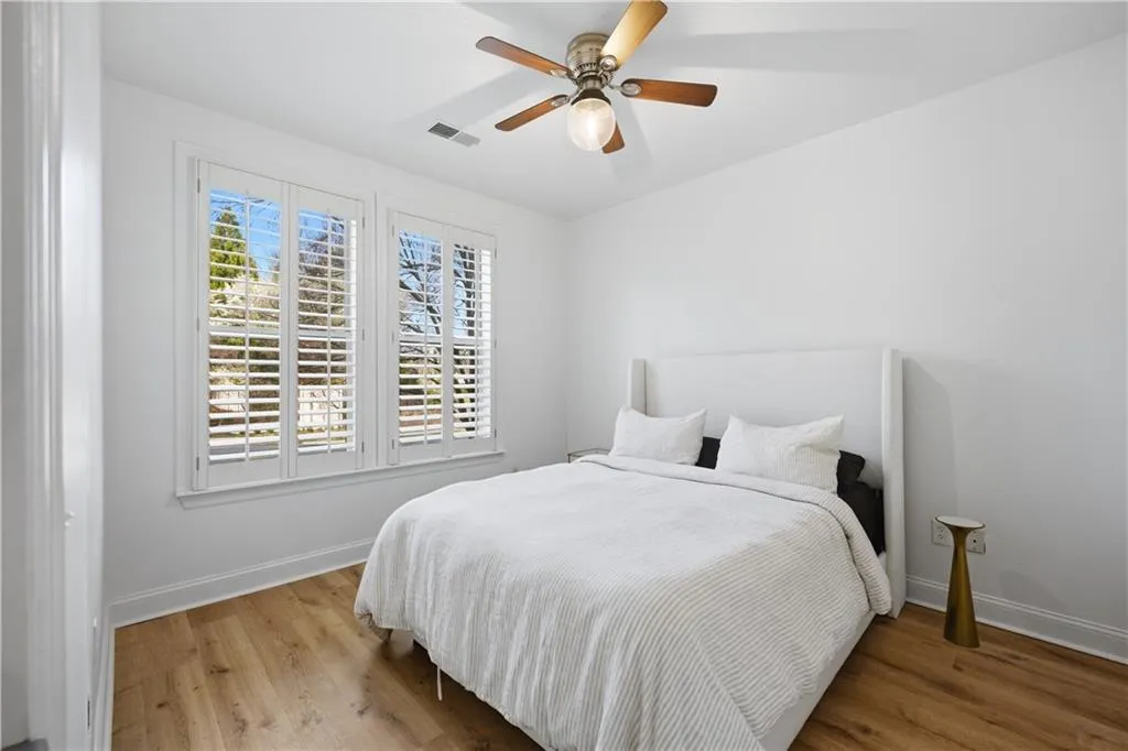 Bedroom with light wood-style floors and a ceiling fan