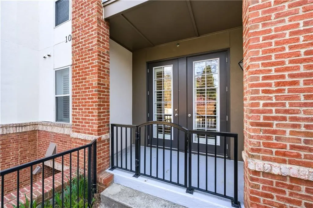 Entrance to property featuring french doors and brick siding