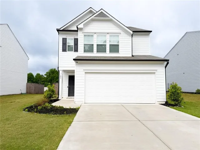 Two-story exterior with white siding, dark shutters, and a two-car garage