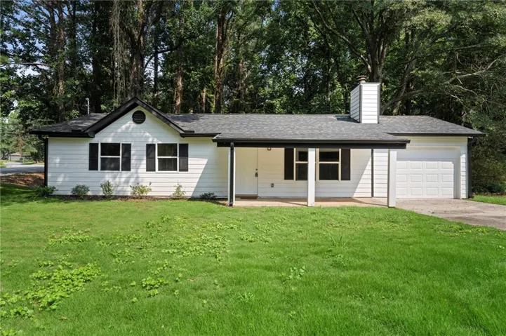 White siding exterior with black trim and a dark shingle roof
