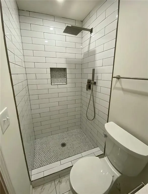 Full bathroom with a shower stall