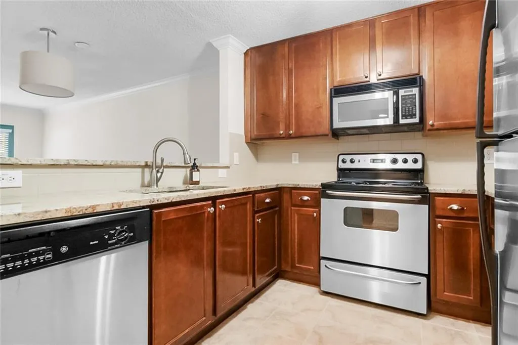 As you walk in the upgraded kitchen is to the right with stainless steel appliance and nice granite.