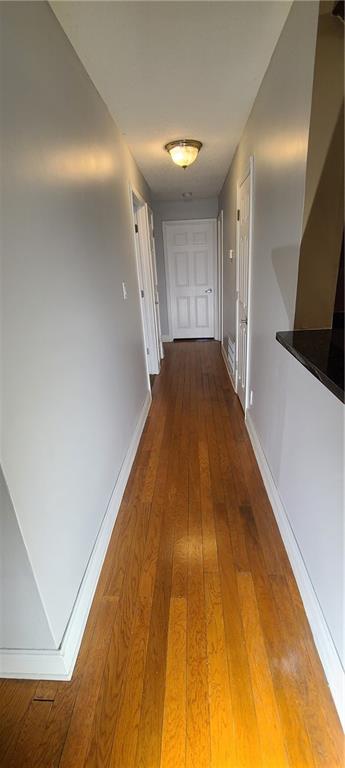 Hallway with wood-type flooring