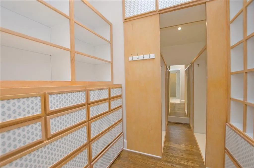 This amazing closet space serves the primary bedroom and has extensive built-ins.