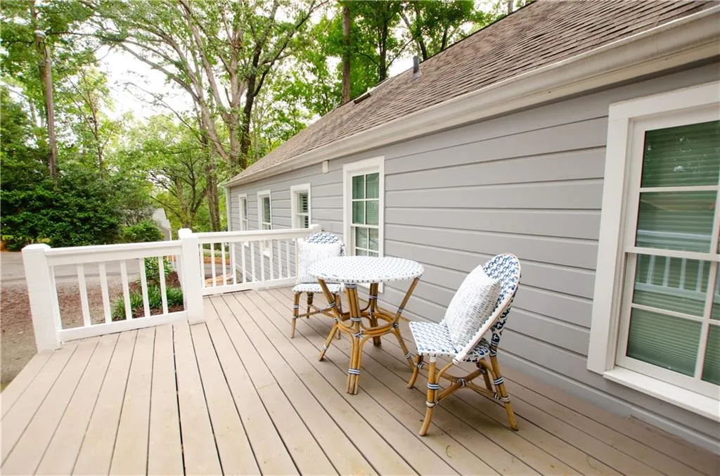 The large deck overlooks the private 1/2 acre level yard with sitting area and room for a grill.