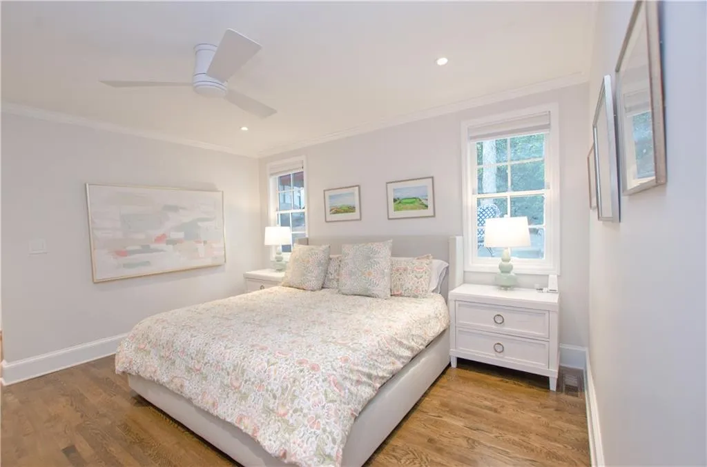 This spacious first floor primary suite had  hardwood floors and an ensuite primary renovated bath.