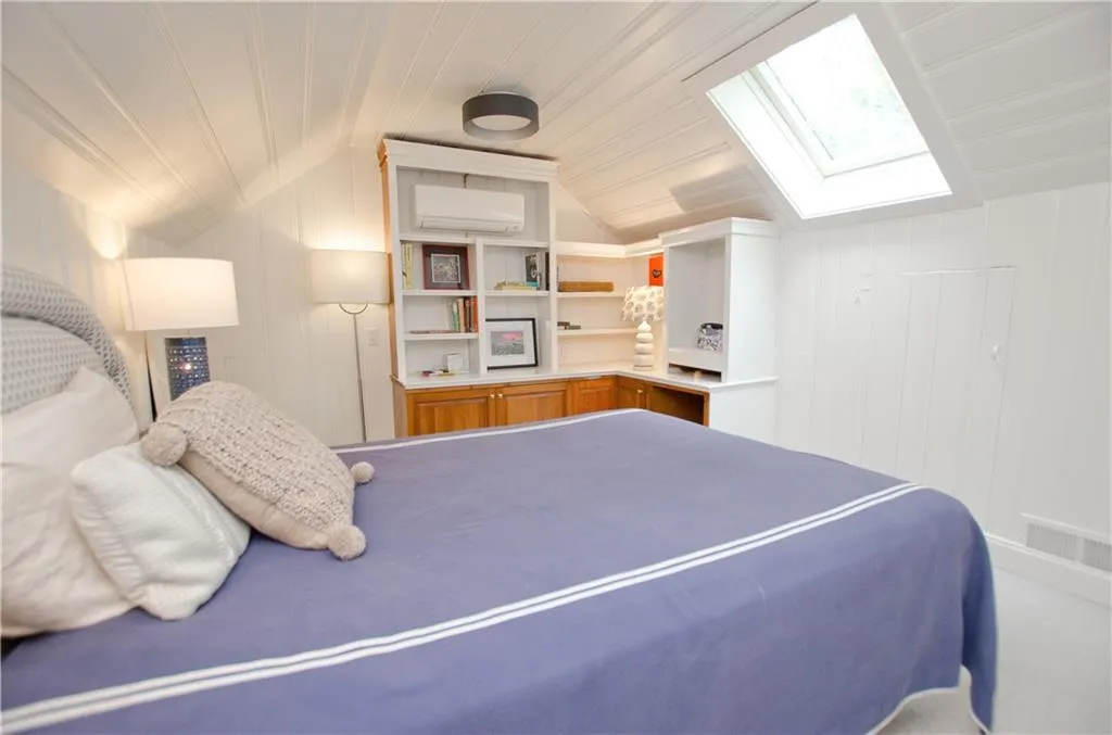 The third bedroom has shiplatch paneling and a skylight as well as cabinets and shelves.  There is new carpeting throughout the upstairs suite.