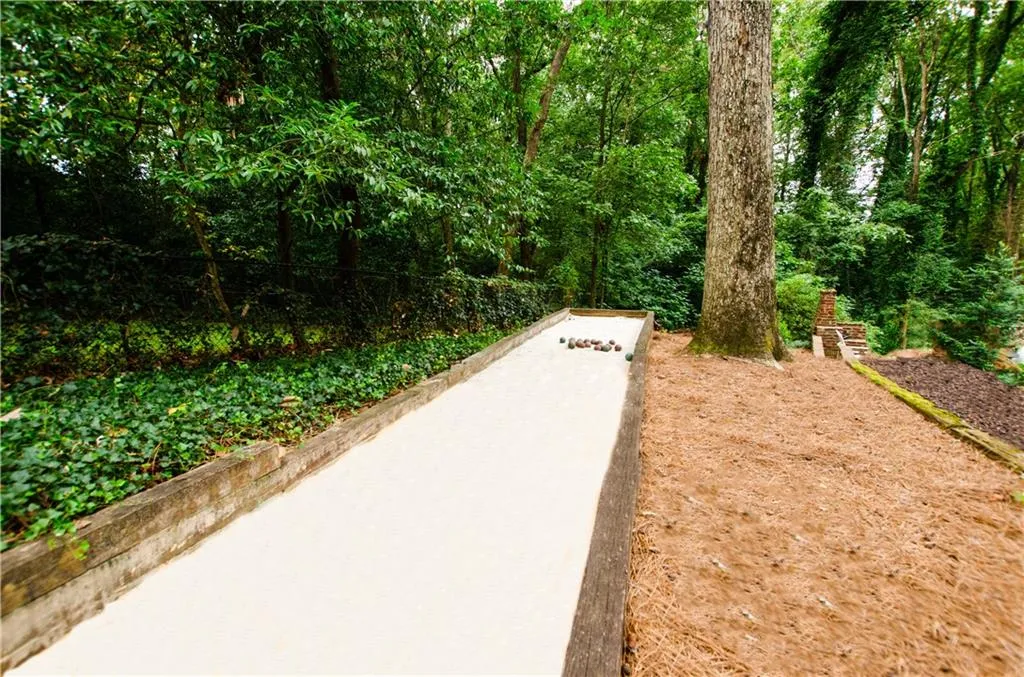 What an amazing back yard with  privacy , room for a pool and even a Bocce Ball Court !