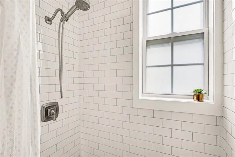 Full Bathroom With A Spacious Tiled Shower