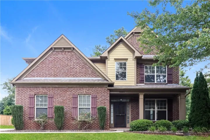 Brick facade home with multiple gables and a covered entry