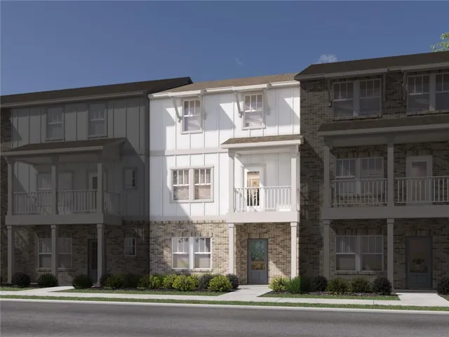 Three-story exterior featuring brick and vertical panel siding