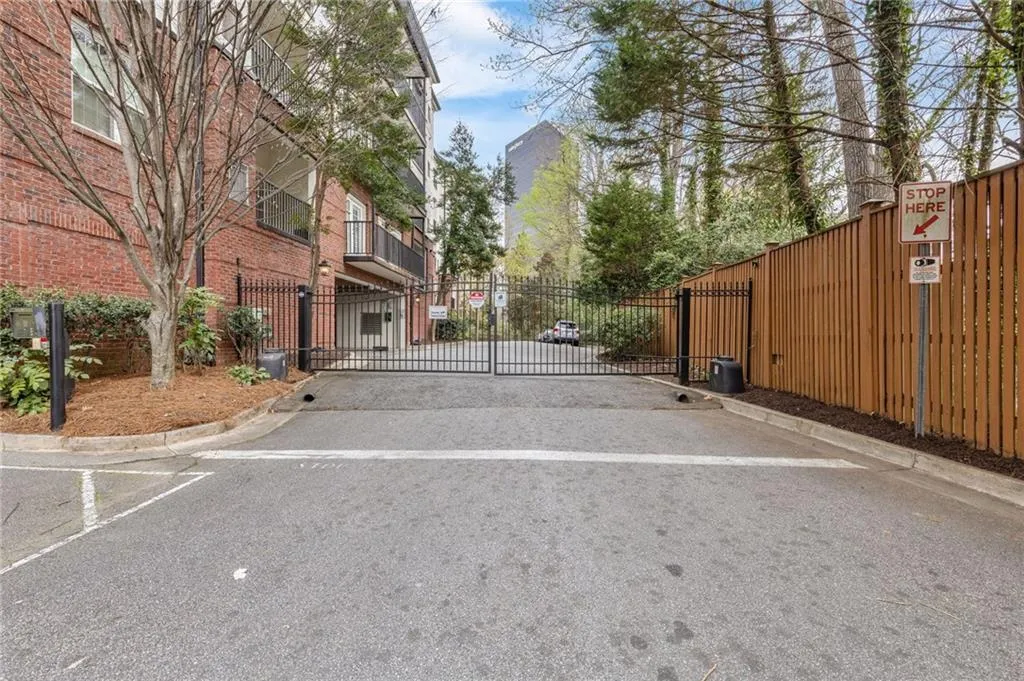 View of parking featuring a gate