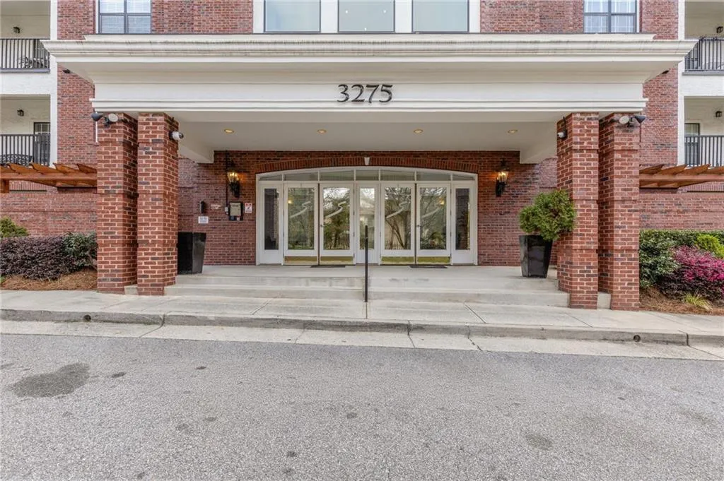 Property entrance featuring brick siding and french doors