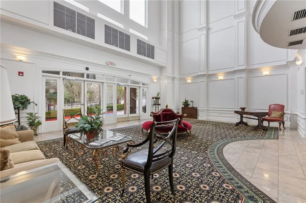 Lobby with a high ceiling and a decorative wall