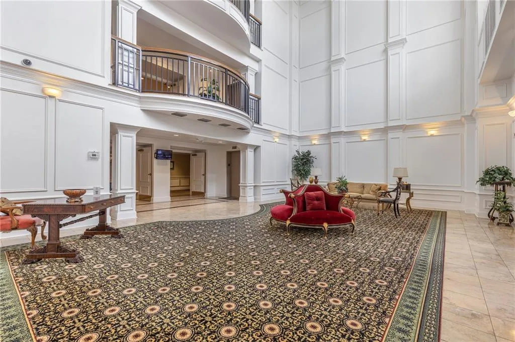 Community lobby featuring a decorative wall and a high ceiling